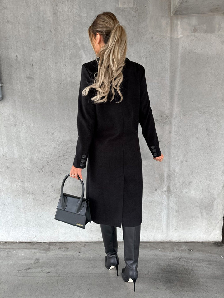 Cozy Vivienne women's long winter coat, stylish and comfortable. Hooded outerwear designed for cold weather warmth.