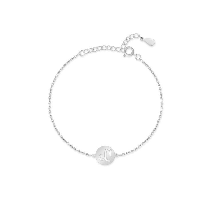 Hand holding a gold plated sterling silver Lyra Zodiac bracelet, showcasing its delicate design
