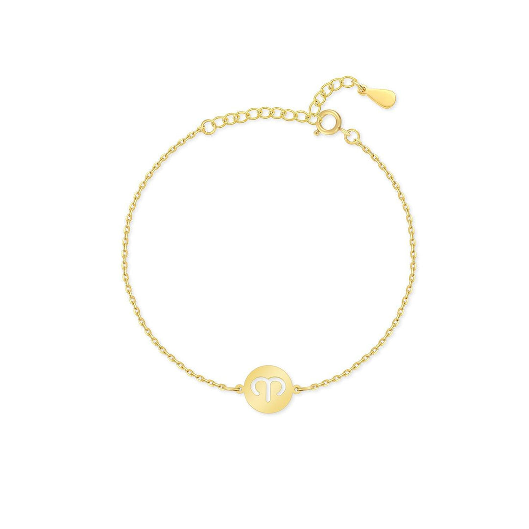 Woman wearing a gold plated sterling silver Lyra Zodiac bracelet, stacking with other jewelry