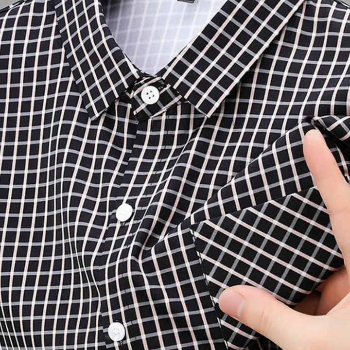 Elegant men's black checked button-down shirt for sophisticated style. Long-sleeve and comfortable.