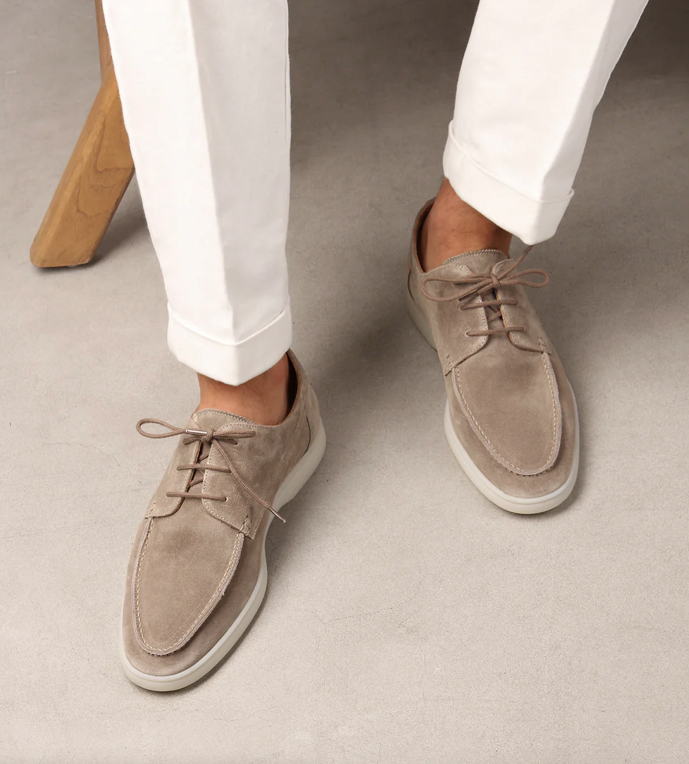 Close-up of premium leather men's loafers, highlighting intricate stitching & sophisticated design.