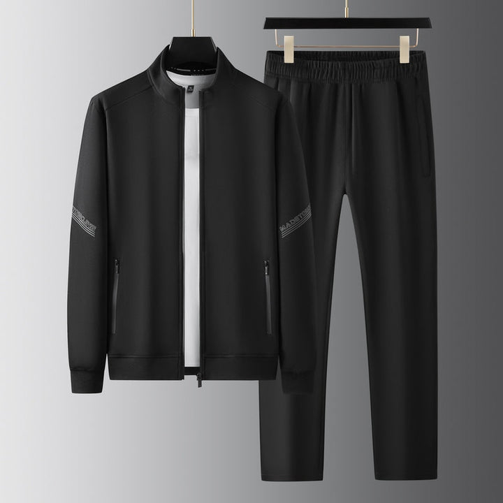 Men's two-piece athletic tracksuit with zip-up jacket & matching pants, comfortable for active sports.