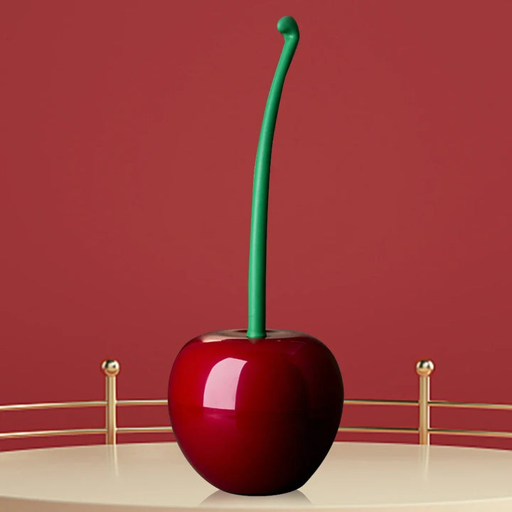 Modern cherry bomb toilet brush in vibrant red. Practical & stylish cleaning tool for effective bathroom hygiene.