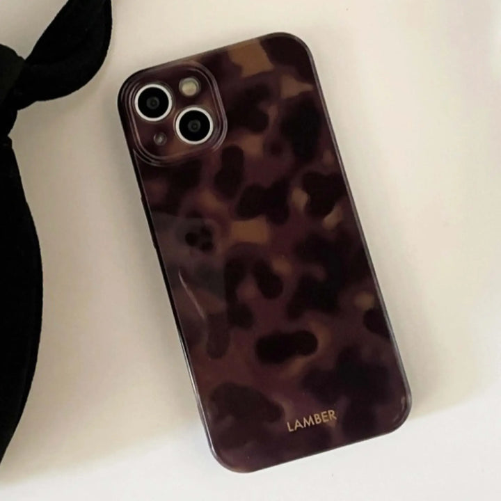 Chic tortoiseshell glass iPhone cover, a luxurious and slim protective case for ultimate device safety.