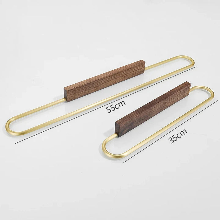 Contemporary walnut wood and brass towel rack. A stylish and functional addition to any modern bathroom.