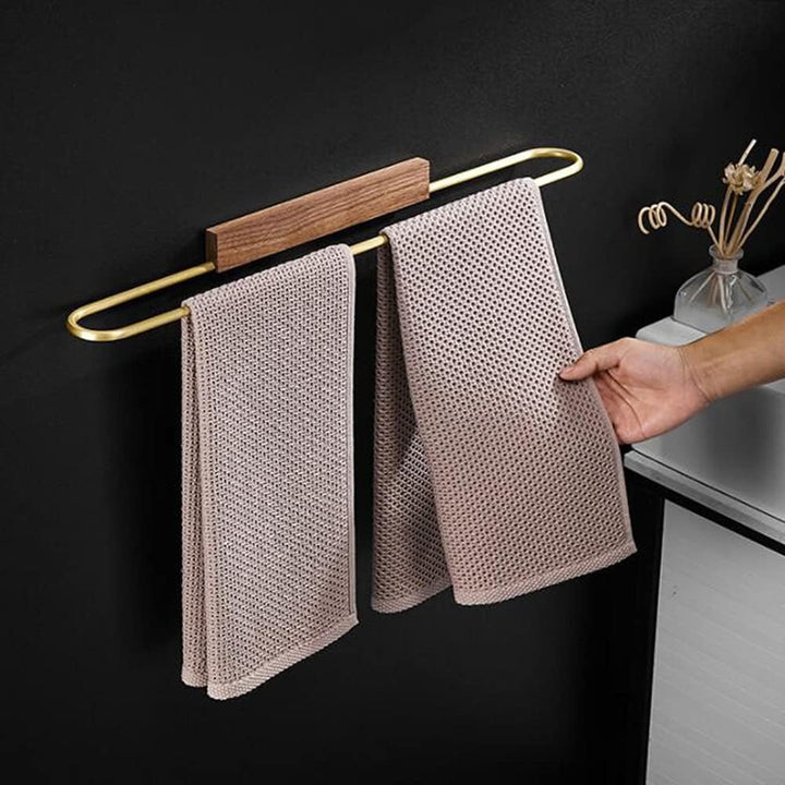 Designer walnut and brass towel bar. Modern bathroom accessory combining rich wood & elegant brass finish.