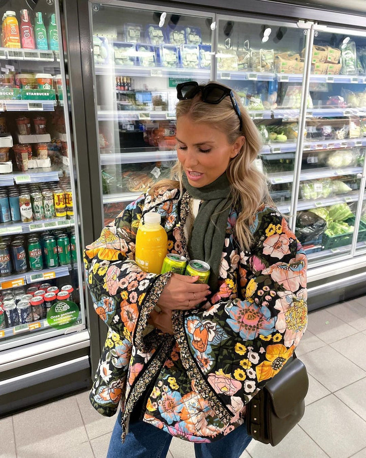 Women's Aurora padded jacket featuring a vibrant floral print. Cozy, windproof & oversized fit outerwear.