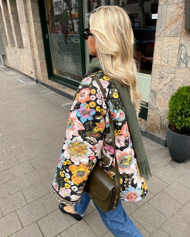 Trendy women's Aurora padded jacket with a beautiful floral design. A fashionable and warm winter coat.
