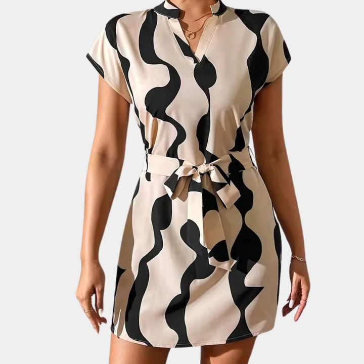 Stylish women's beige belted dress, perfect for spring/summer. Flattering mini dress with a chic, versatile design.