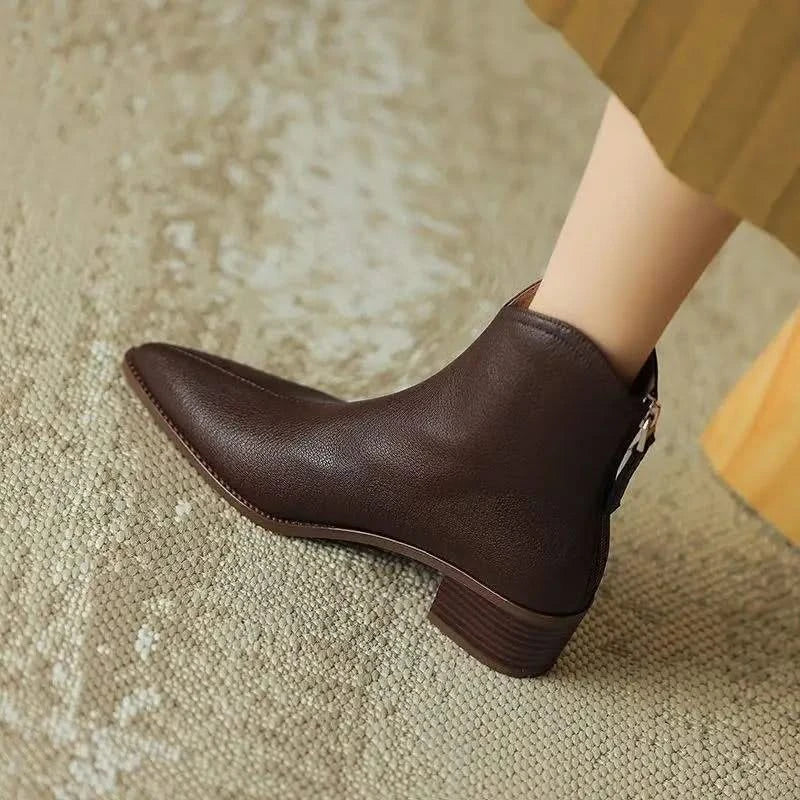 Chic pointed toe design on women's black low heel ankle boots, offering classy style and comfort.