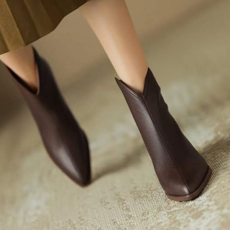 Low heel comfort on women's black pointed toe ankle boots, ideal for stylish winter and fall fashion.