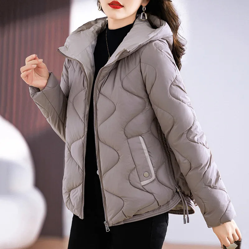 Stylish women's black quilted puffer jacket, offering cozy warmth & winter protection for casual wear.