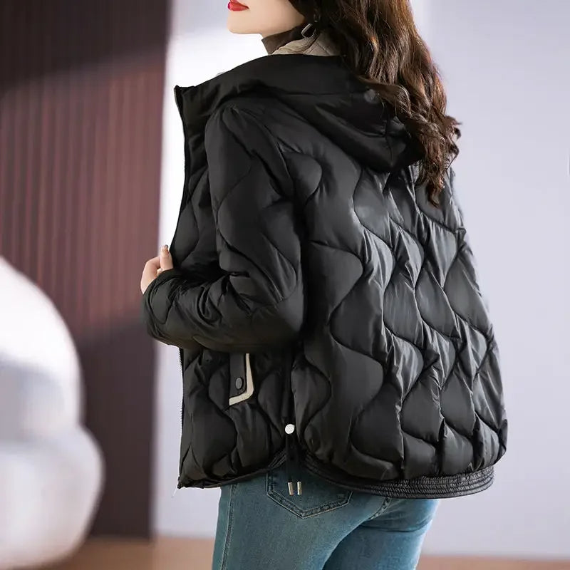 Women's sleek navy blue quilted puffer jacket, a must-have for cold weather and winter adventures.