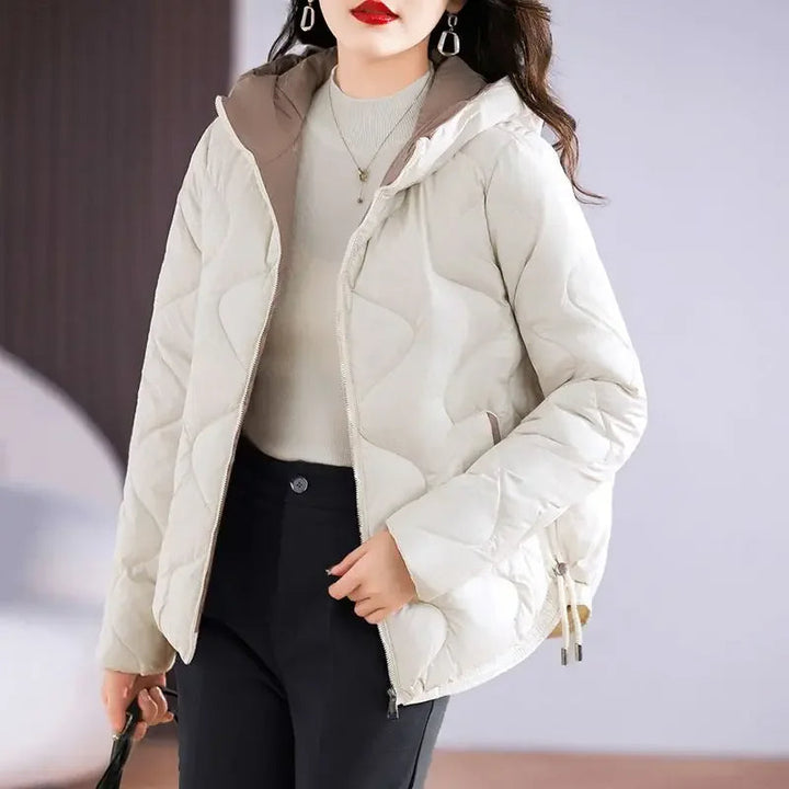 Close-up of the quilted texture on a women's winter puffer jacket, emphasizing warmth and style.