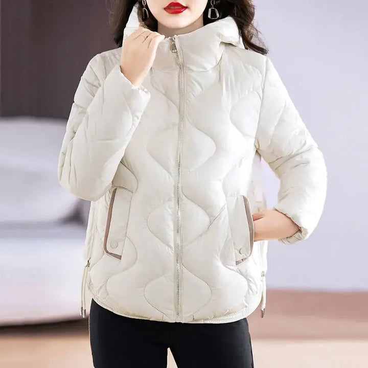 Full-length shot of a women's stylish, insulated puffer jacket, featuring a modern, versatile design.