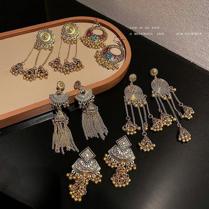 Close-up of unique women's bohemian ethno pendant earrings. Stylish jewelry accessory.