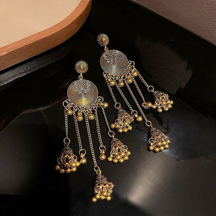 Detailed women's ethno pendant earrings. Bohemian style jewelry, a unique stylish accessory.