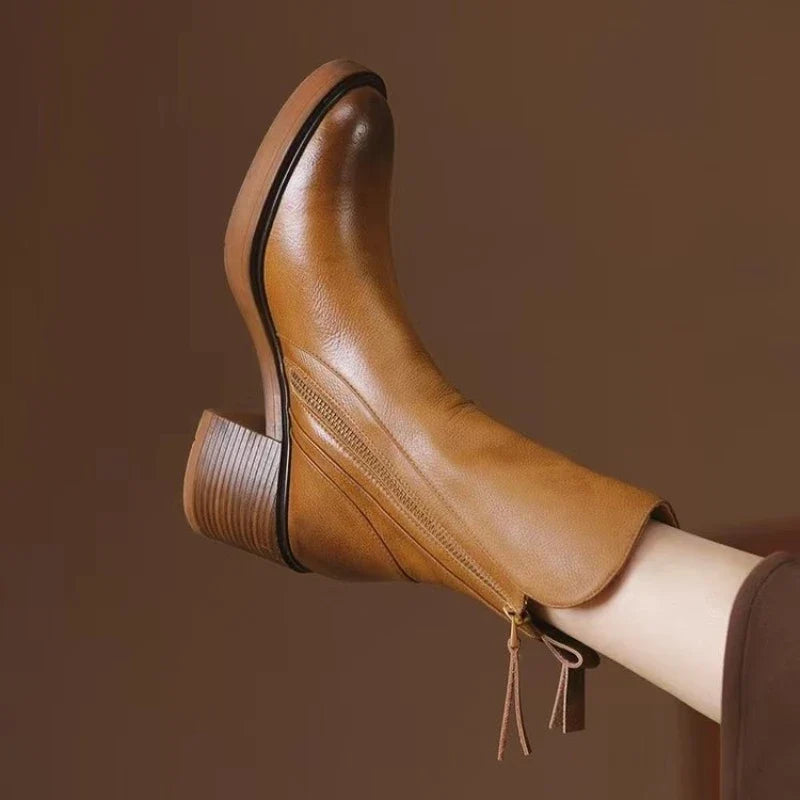 Stylish women's brown high-heel ankle boots, perfect for elegant fall & winter fashion footwear trends.