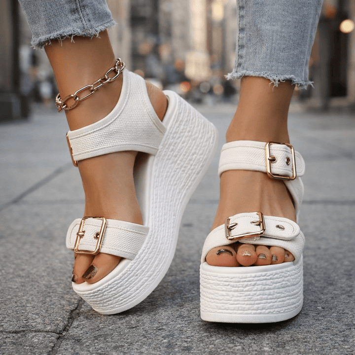 Chic women's buckle wedge sandals, a stylish choice for comfortable, elevated summer fashion.