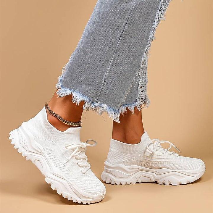 Modern women's chunky sole platform sneakers with lace-up closure, offering stylish comfort for all-day wear & activities.