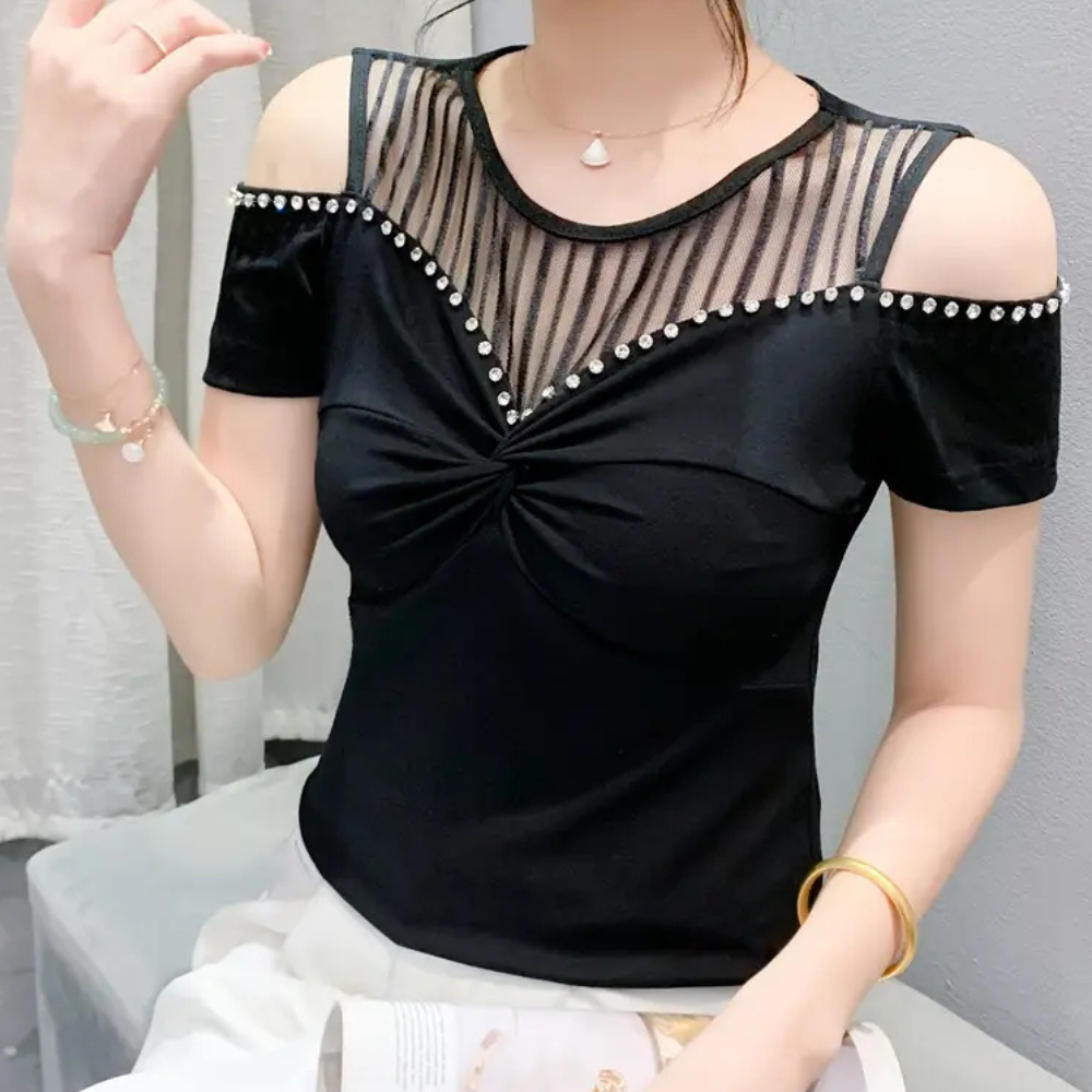Trendy black cold-shoulder top for women. Elegant design with comfortable, versatile wear.