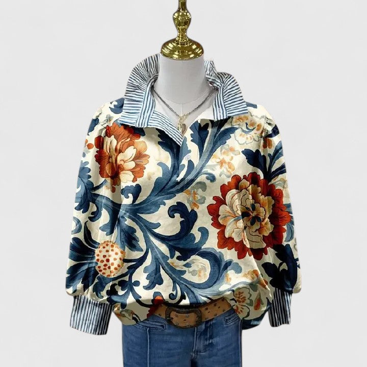Stylish women's dark blue floral blouse with long sleeves, perfect for any occasion. Elegant fashion top.