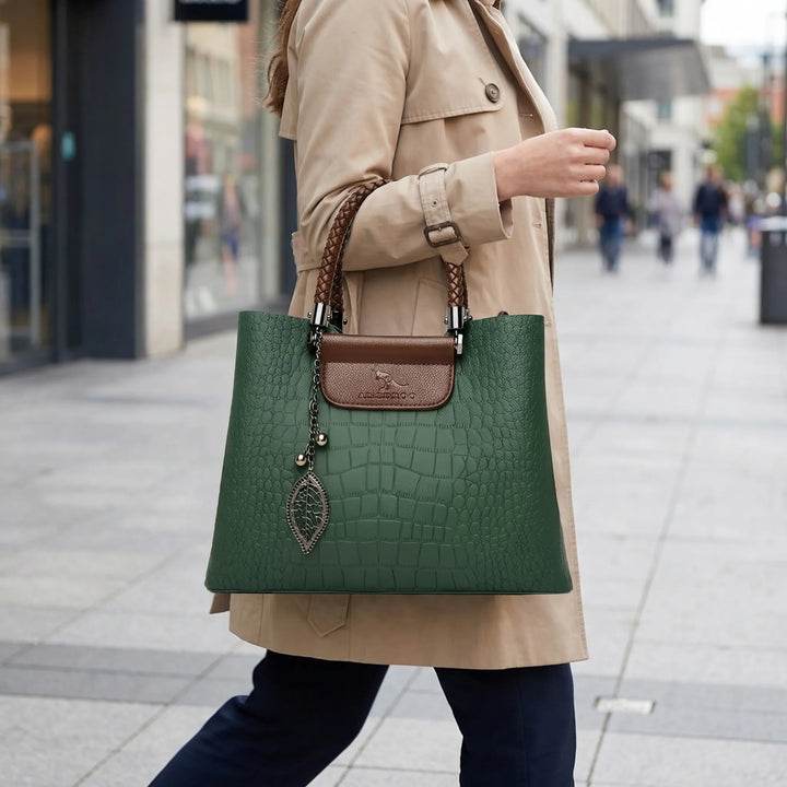 Stylish women's embossed tote bag with a unique braided handle, perfect everyday shoulder carryall.