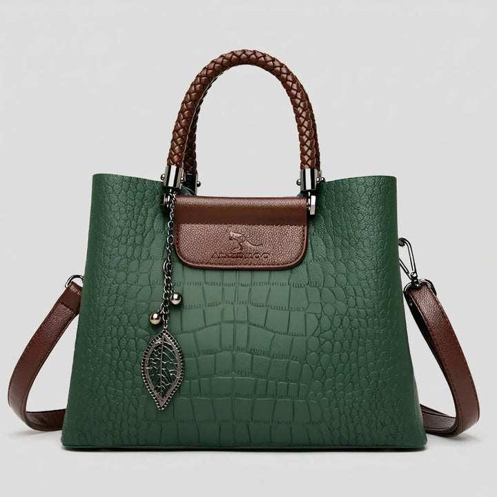 Chic green embossed women's tote bag, featuring a distinct braided handle. A versatile fashion accessory.