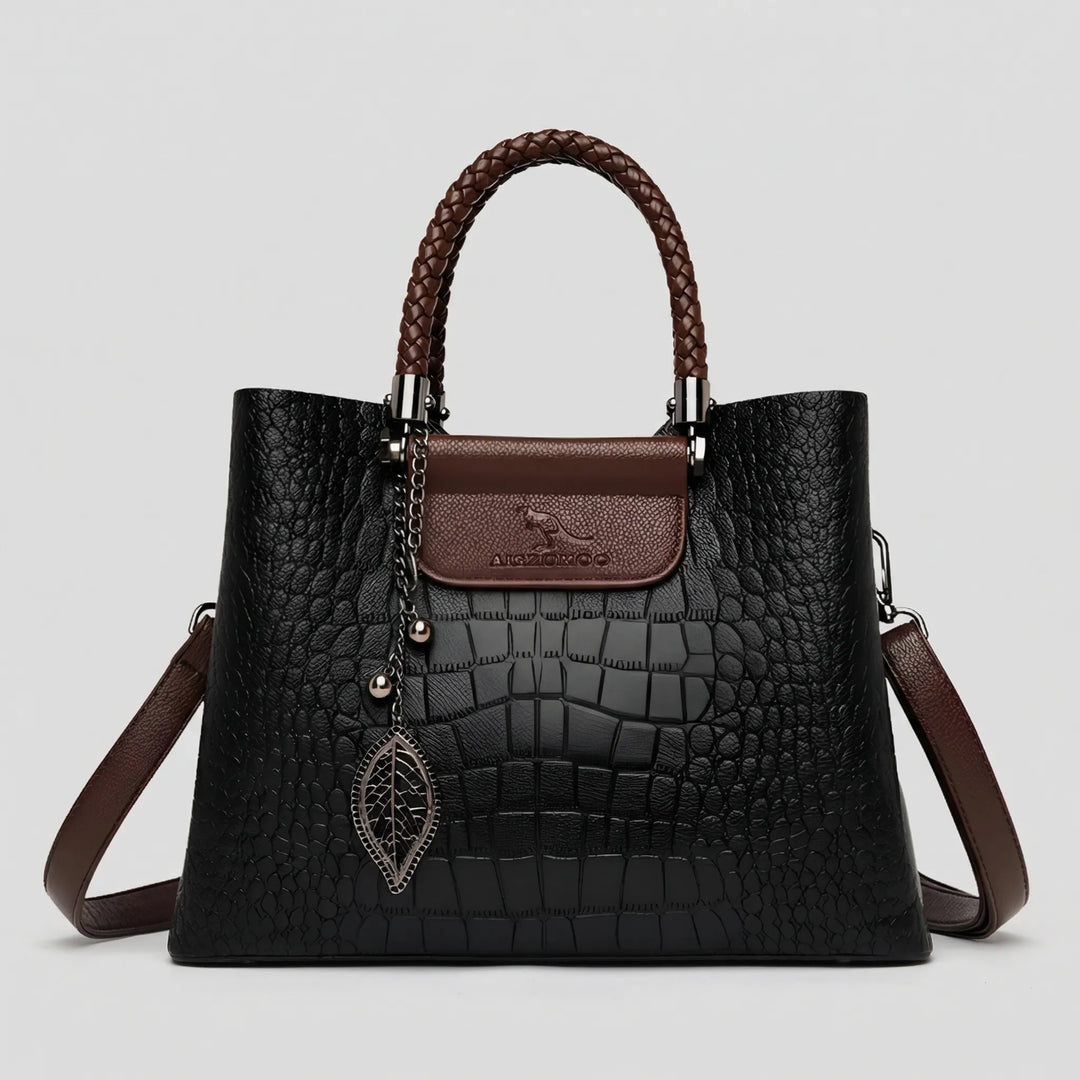 Classic black women's embossed tote bag with braided handle, a versatile & stylish shoulder handbag.