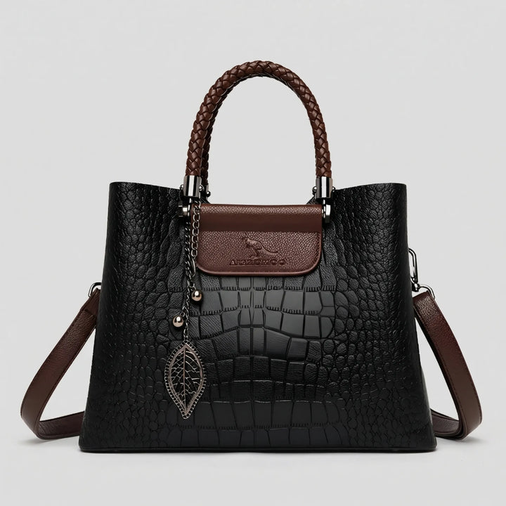 Classic black women's embossed tote bag with braided handle, a versatile & stylish shoulder handbag.