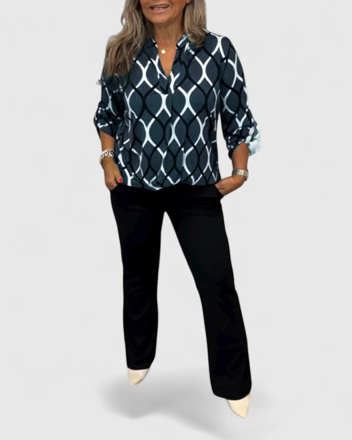 Stylish women's graphic print blouse with three-quarter sleeves, perfect for casual or workwear.