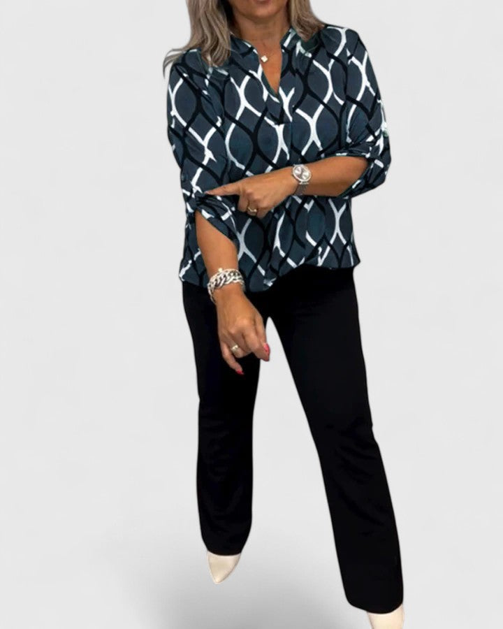 Comfortable loose-fit graphic print women's blouse, versatile for everyday fashion.