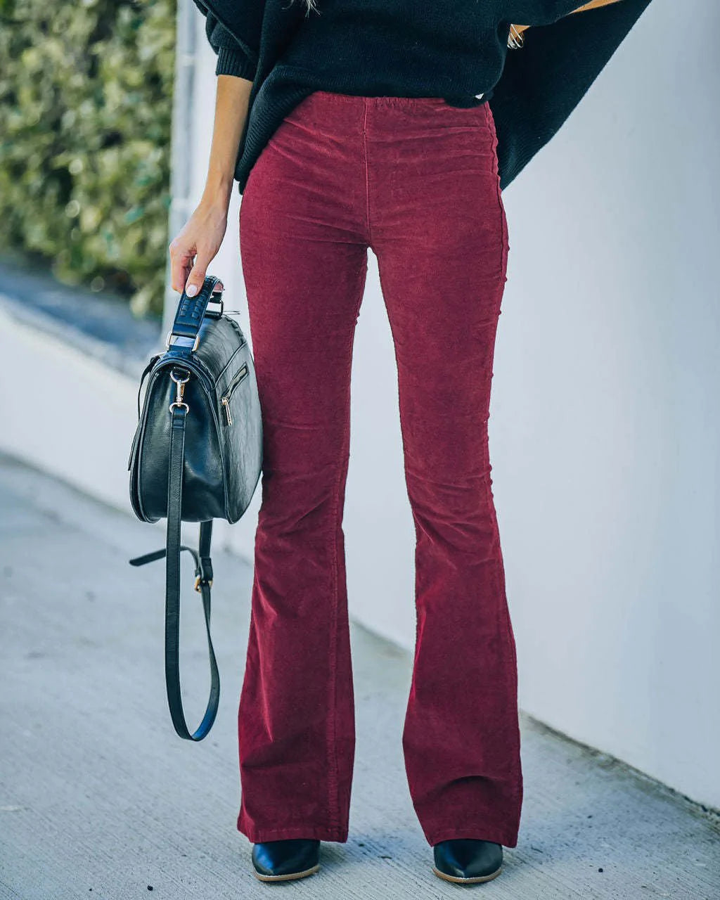 Elegant black high waist flare pants, offering a chic bootcut design for contemporary women's fashion.