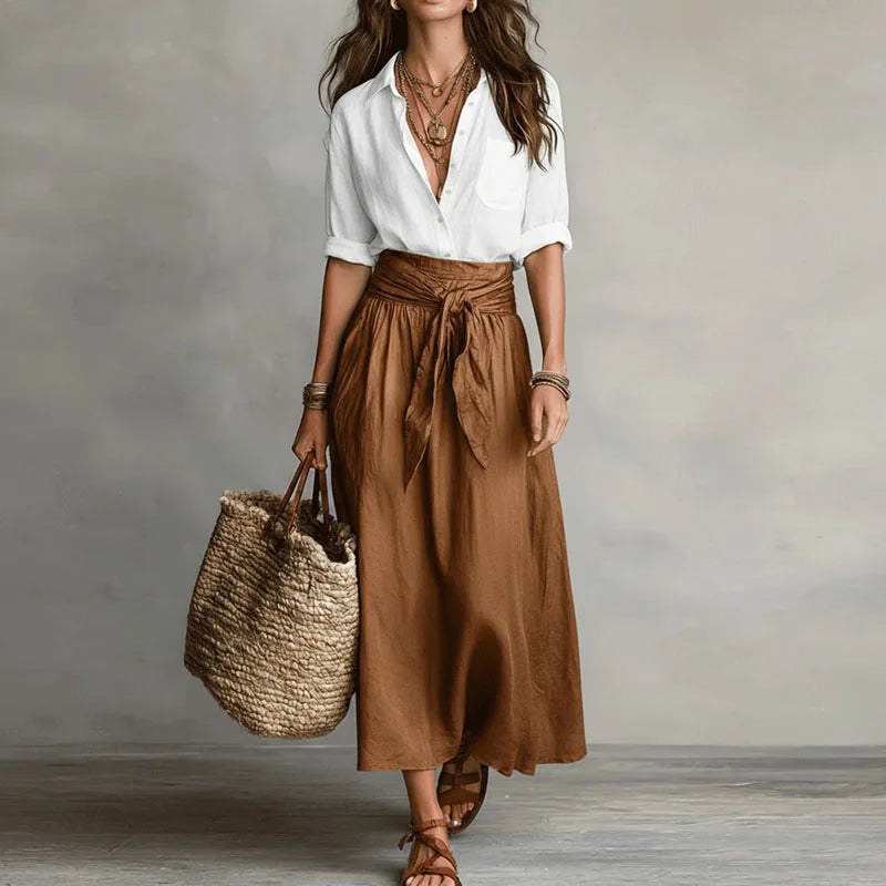 Versatile Women's two-piece Jeanelle skirt set. Effortless long sleeve top paired with a chic tie-waist skirt.