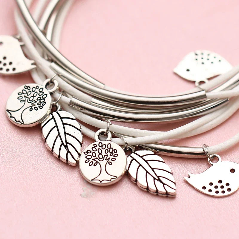 White multi-strand natural leather bracelet worn on wrist, a stylish layered women's accessory.
