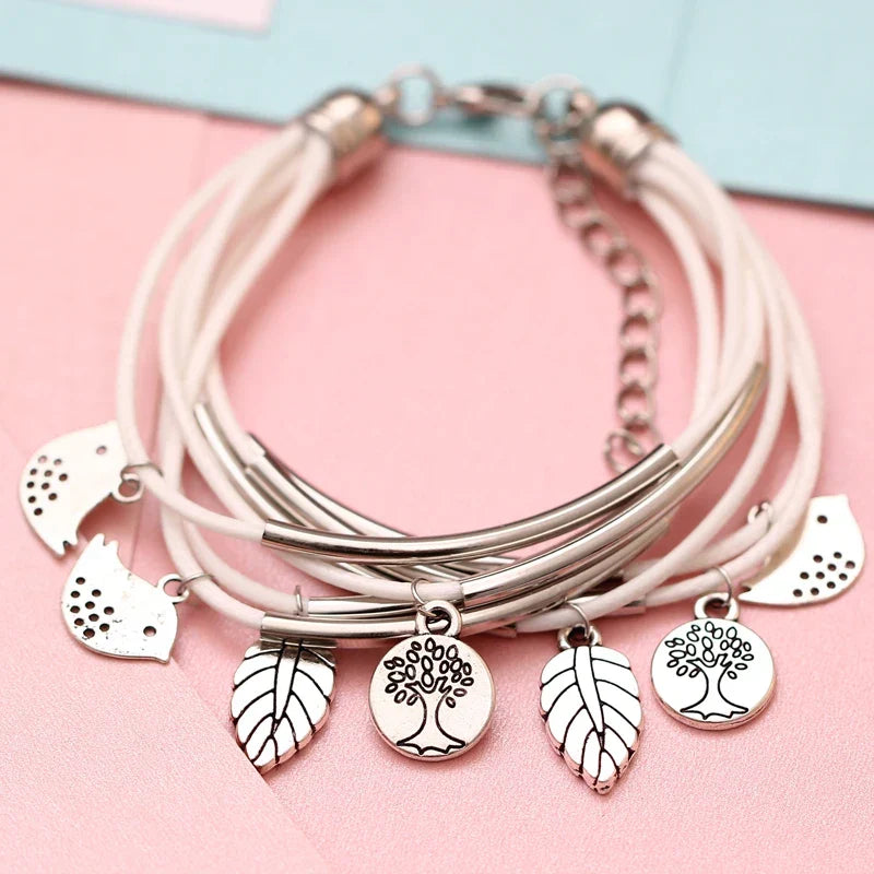 Detail of magnetic clasp on women's beige layered leather multi-strand bracelet.