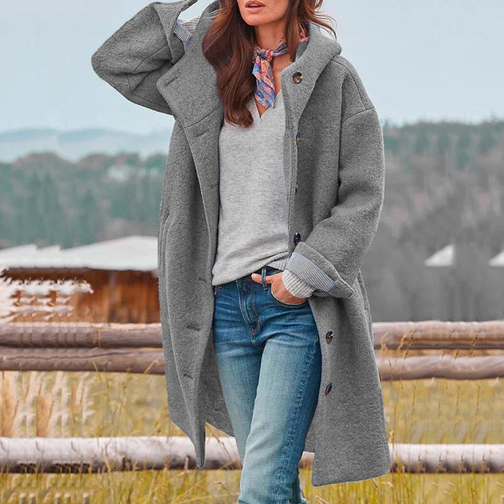 Elegant women's long hooded fall coat, providing stylish comfort and warmth for outerwear.