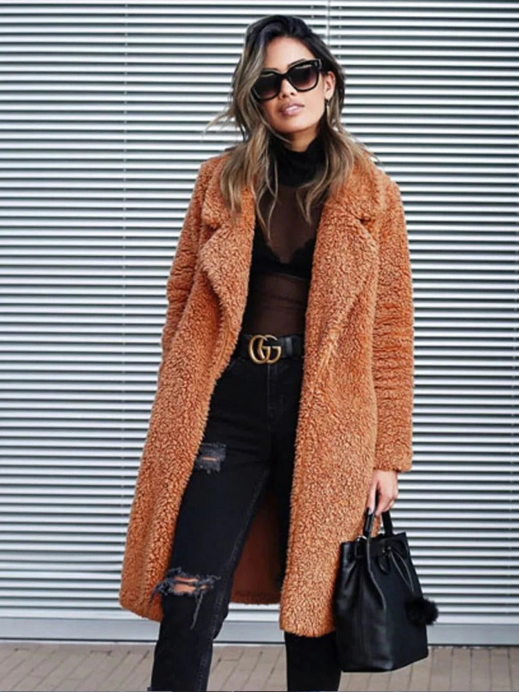 Fashion-forward women's long teddy coat, warm, cozy, & stylish, essential for winter outerwear.