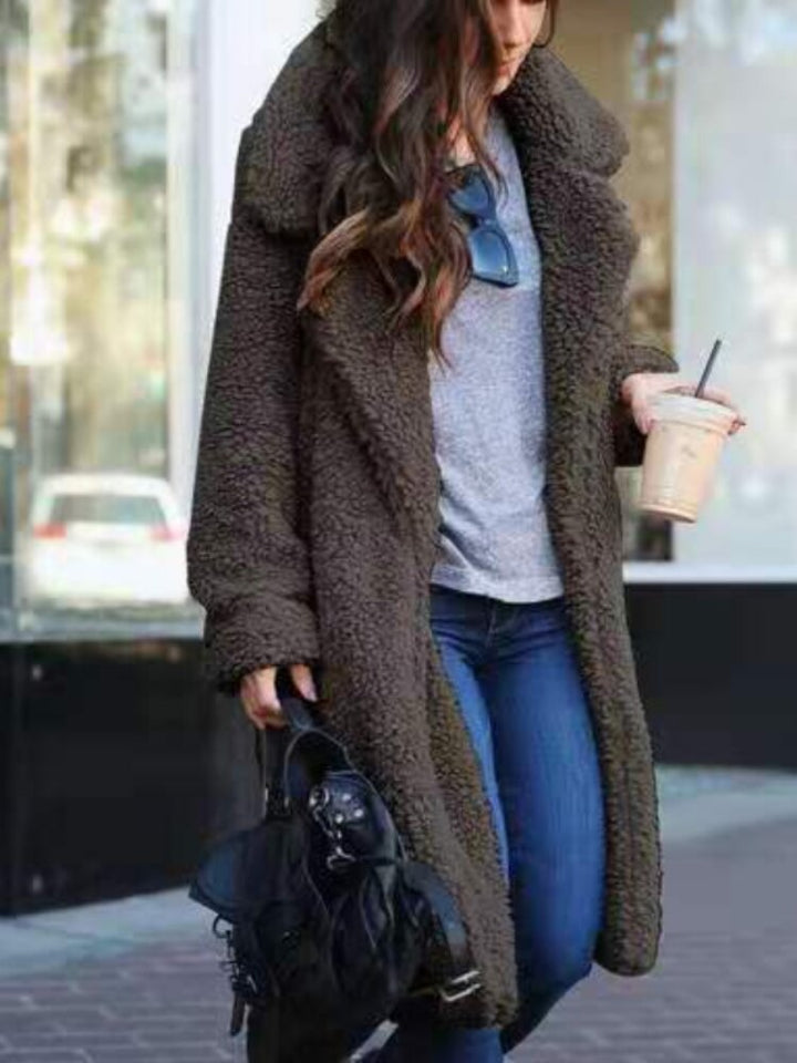 Cozy women's long teddy coat, a stylish oversized winter jacket, perfect for cold weather fashion.