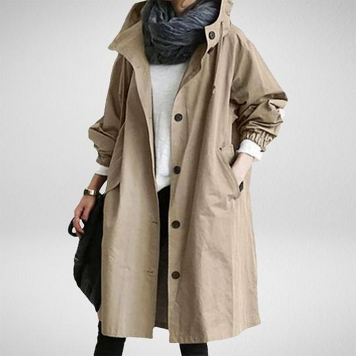 Sleek women's long waterproof raincoat with a hood, windproof, offering ultimate protection & contemporary fashion.