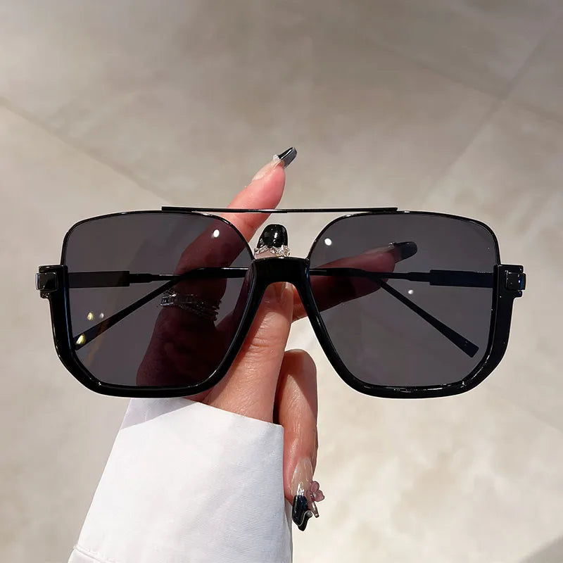 Trendy women's oversized square sunglasses, offering full UV protection for a chic and fashionable look.