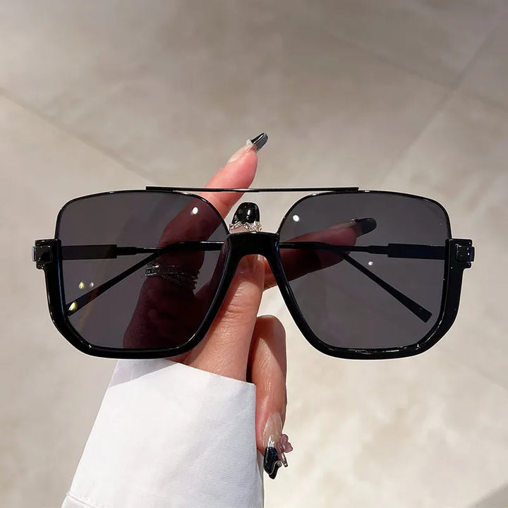Trendy women's oversized square sunglasses, offering full UV protection for a chic and fashionable look.