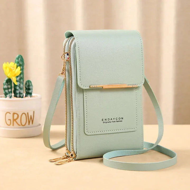 Modern women's compact travel bag: Crossbody design with touchscreen phone pocket for easy, secure access.