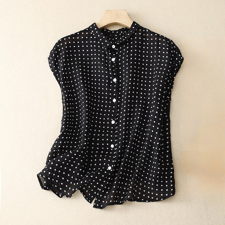 Elegant green polka dot short sleeve blouse for women. A classic summer fashion top, ideal for a refined look.