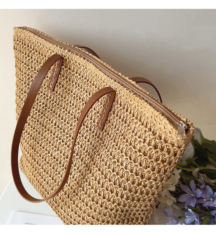 Handwoven rattan women's tote bag with elegant leather straps, a versatile everyday accessory for any outfit.