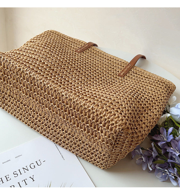 Natural straw bag for women, intricately woven rattan tote with comfortable leather shoulder straps, summer essential.