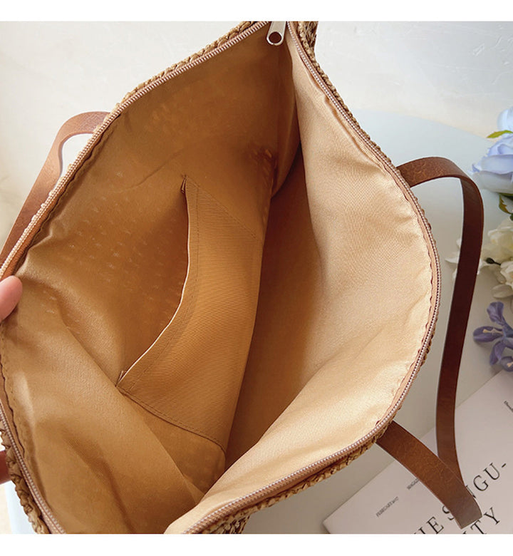 Lightweight women's rattan tote, beautifully woven with genuine leather straps, perfect for beach days & vacation.
