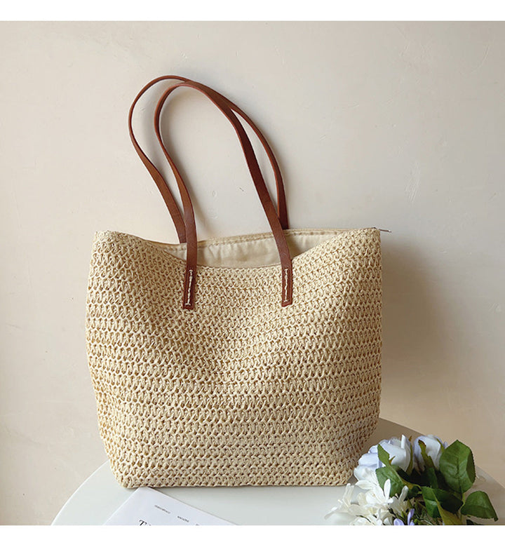 Beautifully handwoven rattan women's tote bag with strong leather straps, a durable and stylish summer accessory.