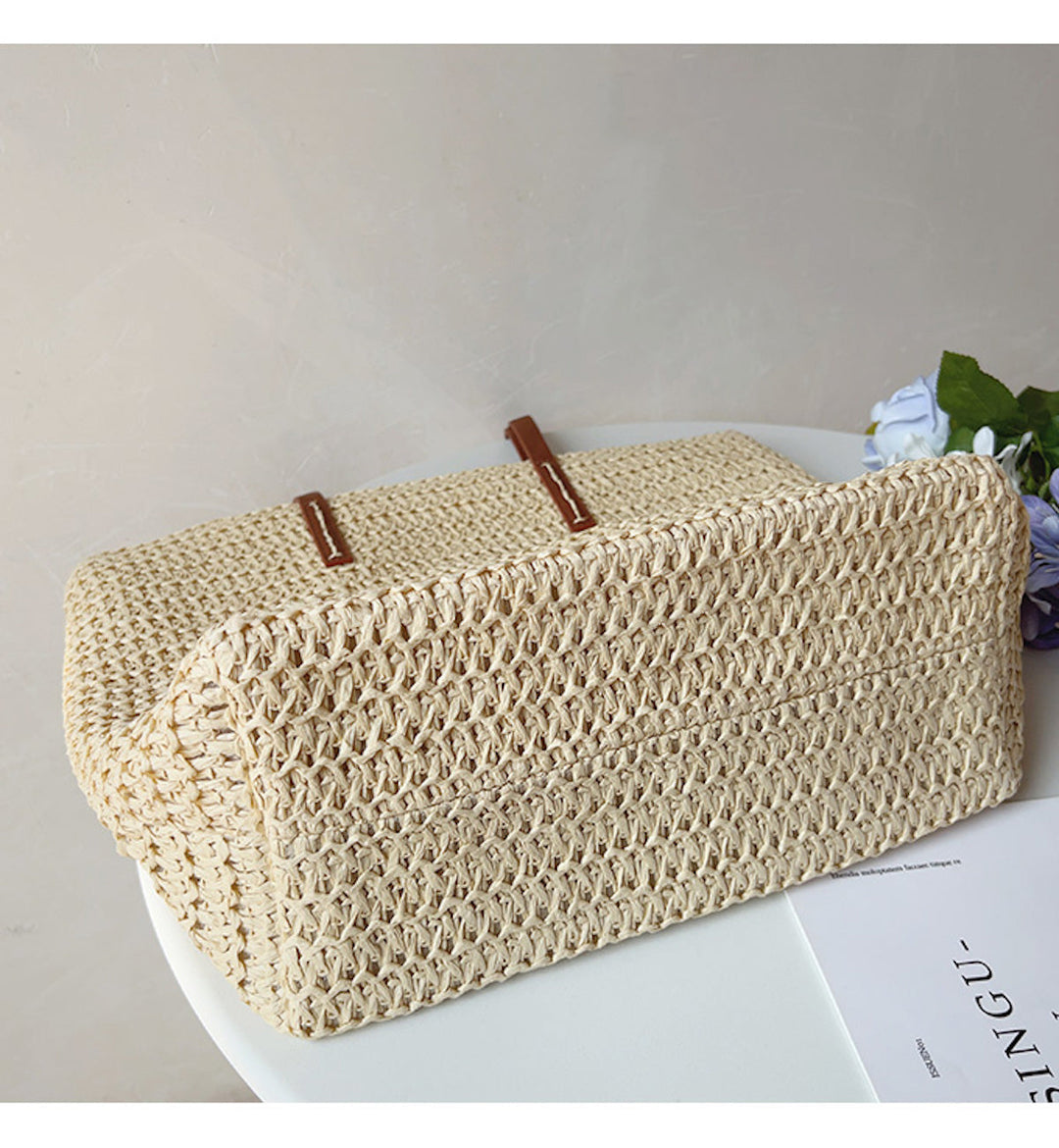 Textured rattan woven tote bag for women, featuring comfortable and chic leather shoulder straps, resort ready.