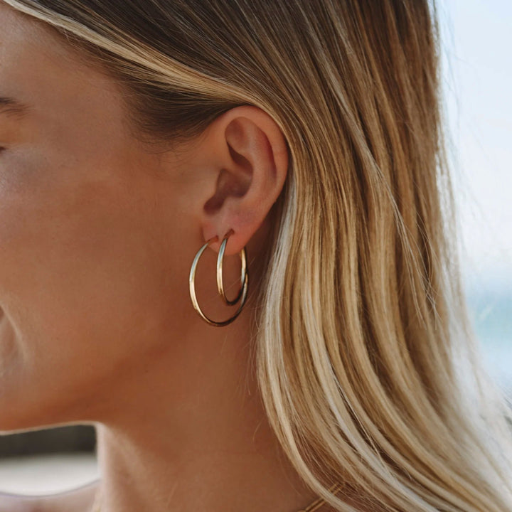 Stylish women's thin hoop earrings, perfect for everyday wear. Delicate and modern gold or silver hoops.